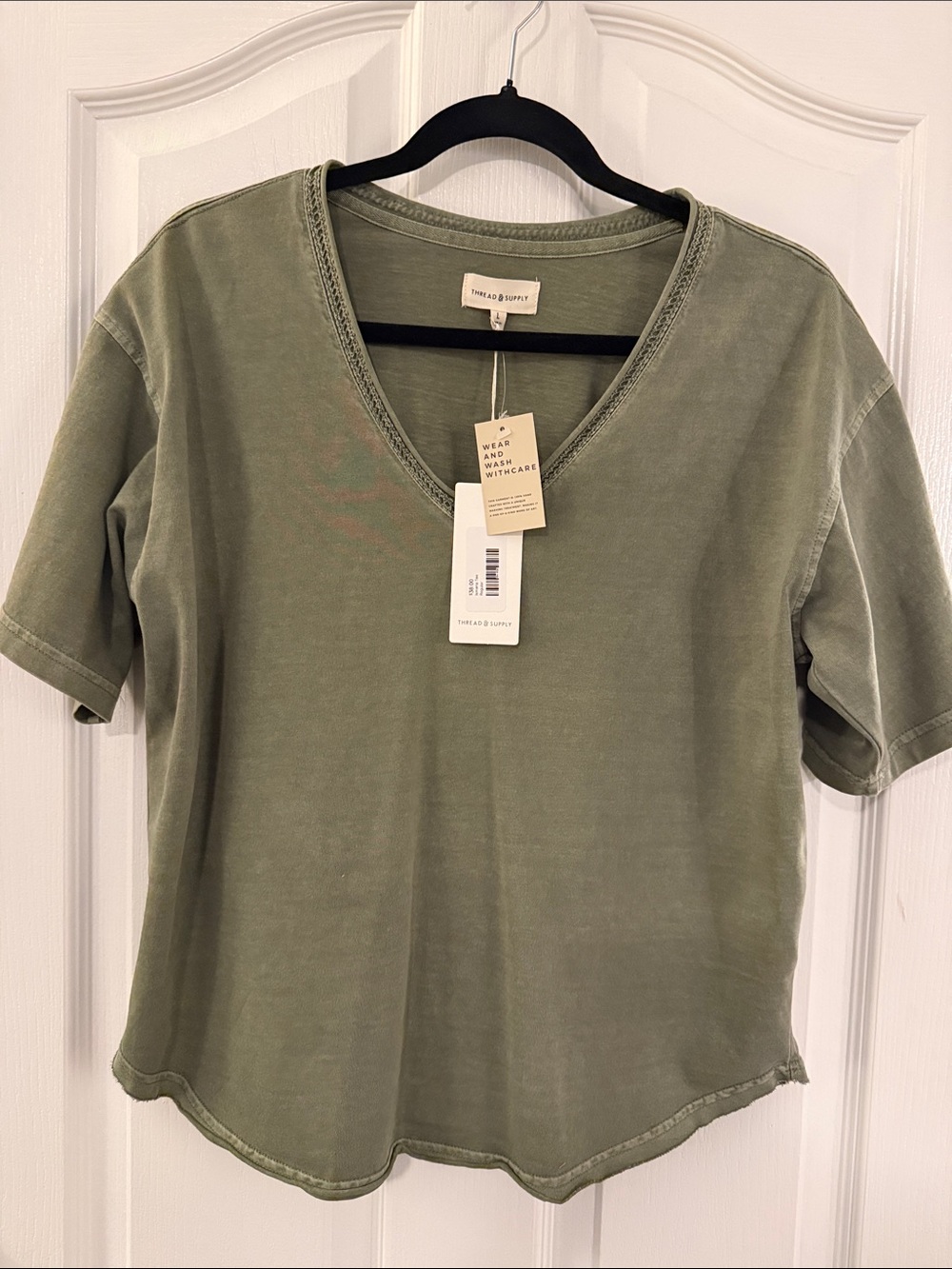 Olive Green Thread & Supply short sleeve v-neck shirt.